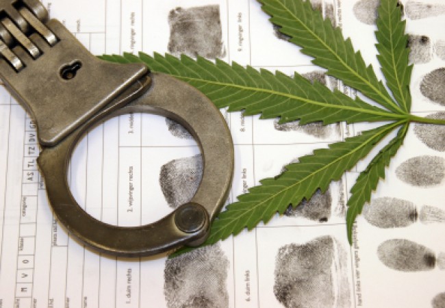 handcuffs and a marijuana leaf